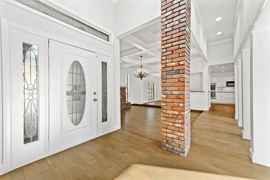 Entrance foyer with ornate columns, coffered ceili