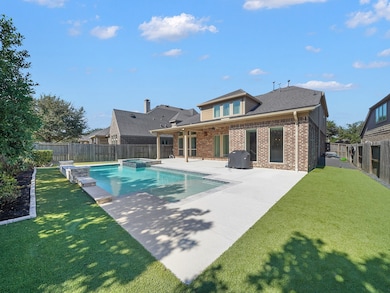 Enjoy your own private retreat! The fenced backyard features a beautiful pool, covered patio, and plenty of space for outdoor lounging or entertaining.