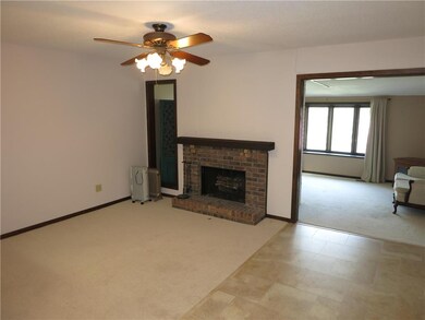 Living room with wood burning fireplace opening to