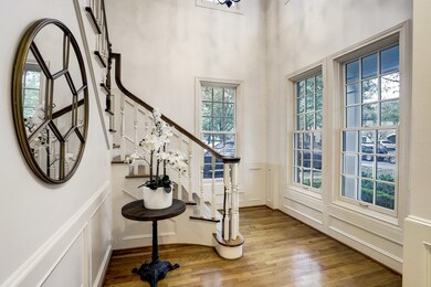 The front entrance opens up to a naturally lite fo