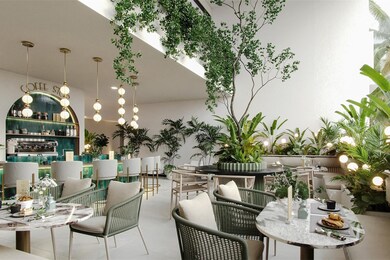 Among the 15 notable amenities, there is a delightful coffee shop and co-working space that stands out with its abundant lush plants and vibrant greenery. This verdant decor transforms the space into a serene and invigorating oasis, perfect for relaxation and socializing. The natural elements create a refreshing and welcoming ambiance, making it an ideal spot to unwind with a cup of freshly brewed coffee, catch up with friends, or even get some work done in a tranquil setting.