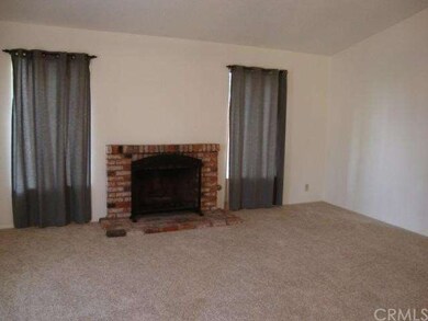 Fireplace with two windows looking out to the stre