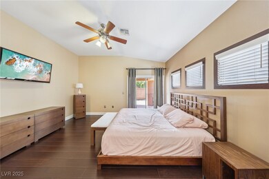 Bedroom featuring lofted ceiling, visible vents, a