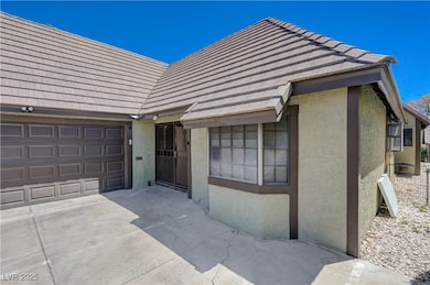 View of front facade with stucco siding, concrete