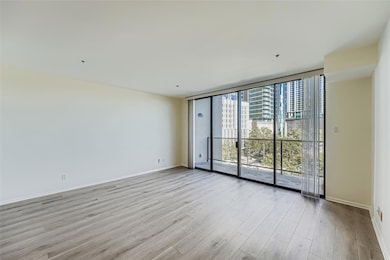 Spare room featuring floor to ceiling windows, li