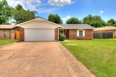 Single story home with a garage, brick siding, and concrete driveway