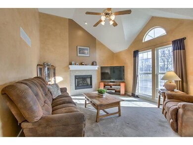 Living room with vaulted ceiling and fireplace