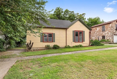 View of front of home with a shingled roof and a front yard