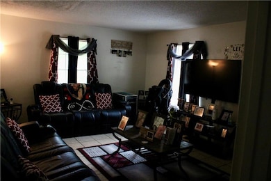 Tiled living room with a textured ceiling