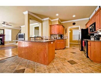 Kitchen. Oak cabinets, granite, SS appliances, tile floor and crown