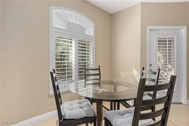 Dining room featuring light tile patterned floors and baseboards
