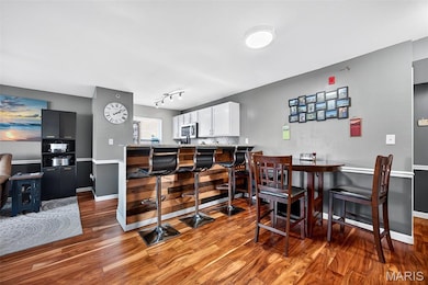 Dining space with wood finished floors and baseboards