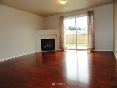 Family room with a gas fireplace looking out to the backyard. 