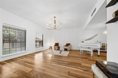 Sitting room featuring a chandelier, wood finishe