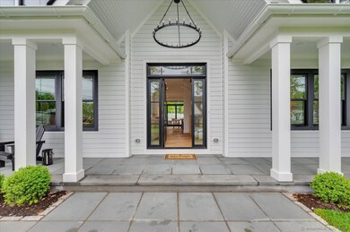 Elegant Marvin floor-to-ceiling door opening to the stunning foyer