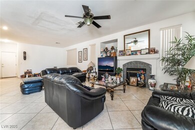 Living area with a ceiling fan, light tile pattern