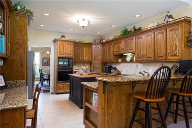 Tons of cabinet space, a huge island, bar seating and even a desk area — this kitchen layout makes smart use of space, and has a lot to go around, too. 