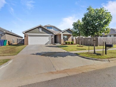 View of front of home with a front yard and a garage