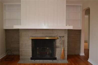 Wood-burning stone fireplace with custom built-ins