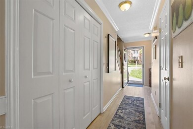 Entry...Laundry closet shown on the left. Half bathroom behind door on right.