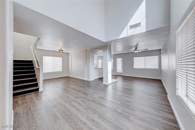 Unfurnished living room with a ceiling fan, wood f