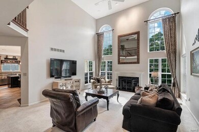 Great room with wood burning fireplace, wall of wi