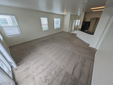 Unfurnished living room featuring carpet flooring,