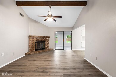 Unfurnished living room featuring beam ceiling, wo