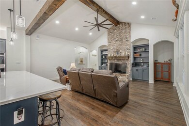 Living area featuring arched walkways, dark wood-s