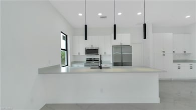 Kitchen featuring modern cabinets, light counterto