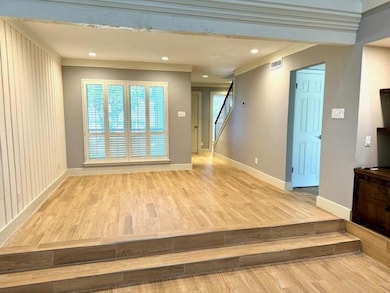 Unfurnished living room featuring wood finished f