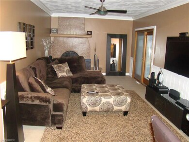 LARGE FAMILY ROOM WITH CERAMIC TILE THAT LEADS TO PATIO