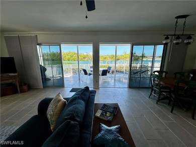 Living area with healthy amount of natural light, a water view, and a ceiling fan