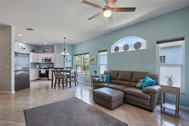 Living room with light tile patterned floors, a ce