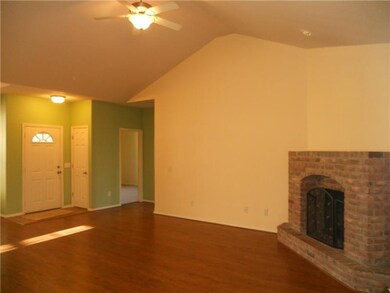 Living Room. Tasteful earth tone walls and hardwood floors.  Open to both formal dining and kitchen/nook.