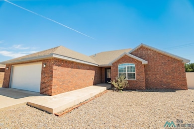 Ranch-style house featuring brick siding, roof with shingles, concrete driveway, and a garage