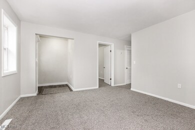 Living room with carpet flooring and baseboards