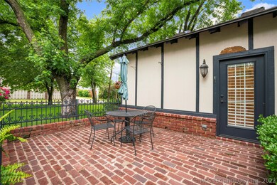Brick courtyard with detailed fence, opens into ma