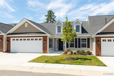 View of front of house with a garage and a front l