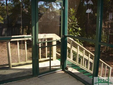 Small deck with stairs leading to back yard