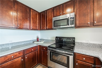 Kitchen featuring stainless steel appliances and l
