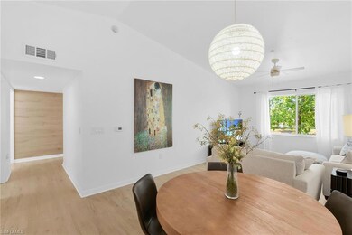 Dining area featuring light wood finished floors, baseboards, ceiling fan, and lofted ceiling