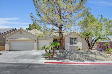 View of front of property with a garage, stucco si