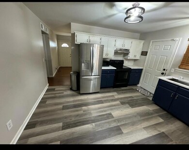 Kitchen with blue cabinets, white cabinetry, light