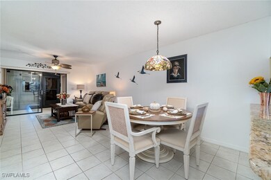 Dining space with ceiling fan and light tile patte