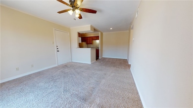 Unfurnished living room featuring ceiling fan, cro