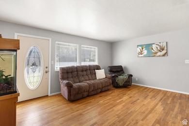 Living area with light wood finished floors and baseboards