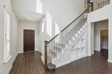Foyer entrance featuring wood finished floors, a 