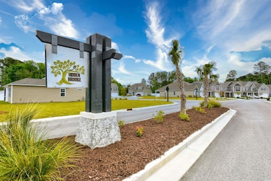 Community sign with a residential view and a yard