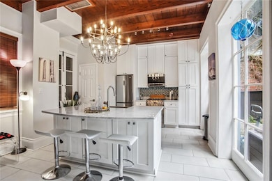 Beautiful eat-in kitchen with gas range, lots of cabinet space and a half bath to the left